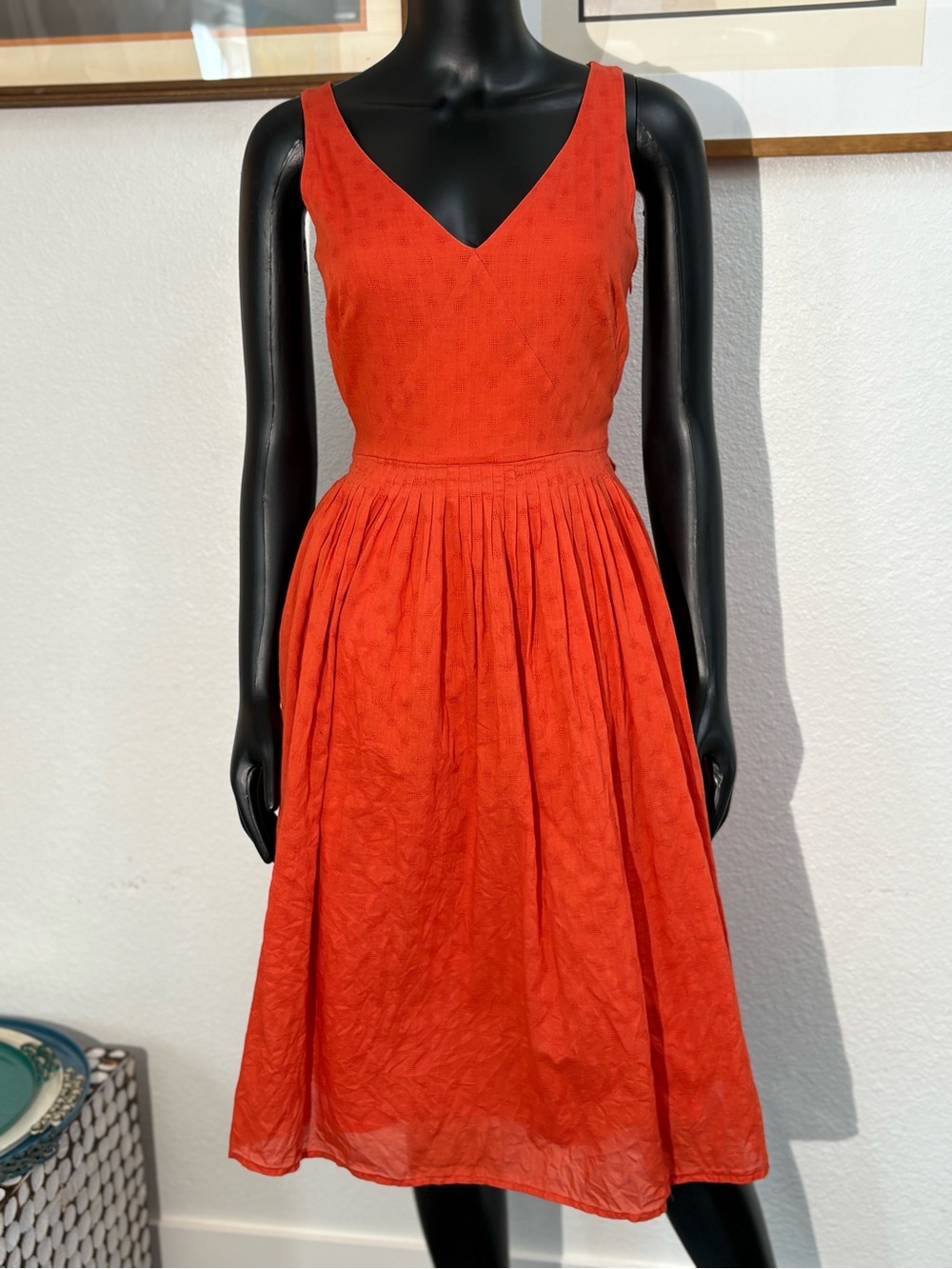 J.Crew orange dress features a V-neck, waist tie, and a pleated skirt